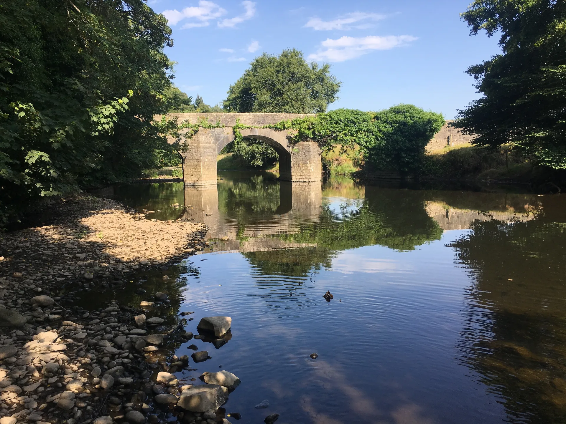 The historic wooden bridge crossing the River Ogmore