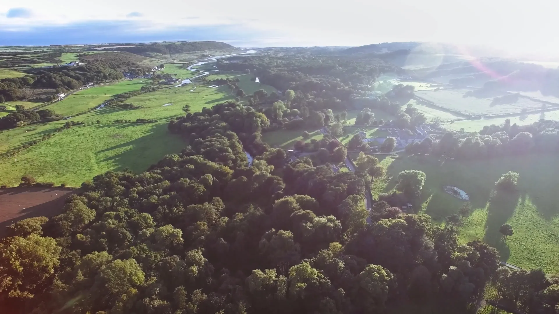 Landscape view across Merthyr Mawr Estate, showing the 840-acre National Nature Reserve with rolling green fields, ancient woodland, and the historic village